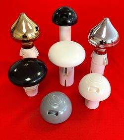 lots of flagpole tops all colours on a table