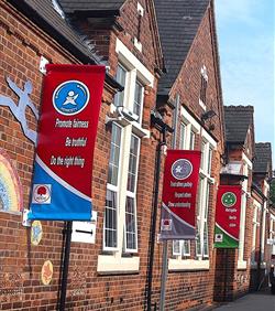 banners displayed in a school playground on banner poles
