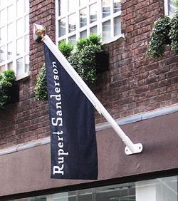 Rupert Saunders flag flying from a angled wall mounted flagpole