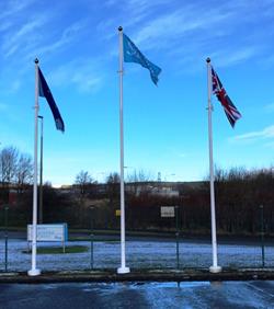 three fibreglass flagpoles with flags flying