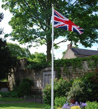 Classic fibreglass flagpole with external halyard and gold finial for UK schools and public buildings.