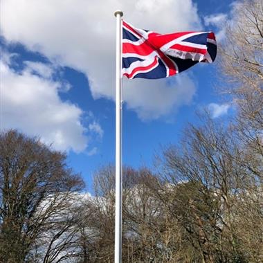 white classic aluminium flagpole flying a union jack flag