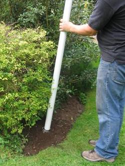 flagpole ground socket in a garden