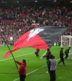 hand waving flag at a football match