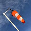 orange and white windsock on a windsock mast