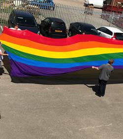 Large Pride flag in carpark,